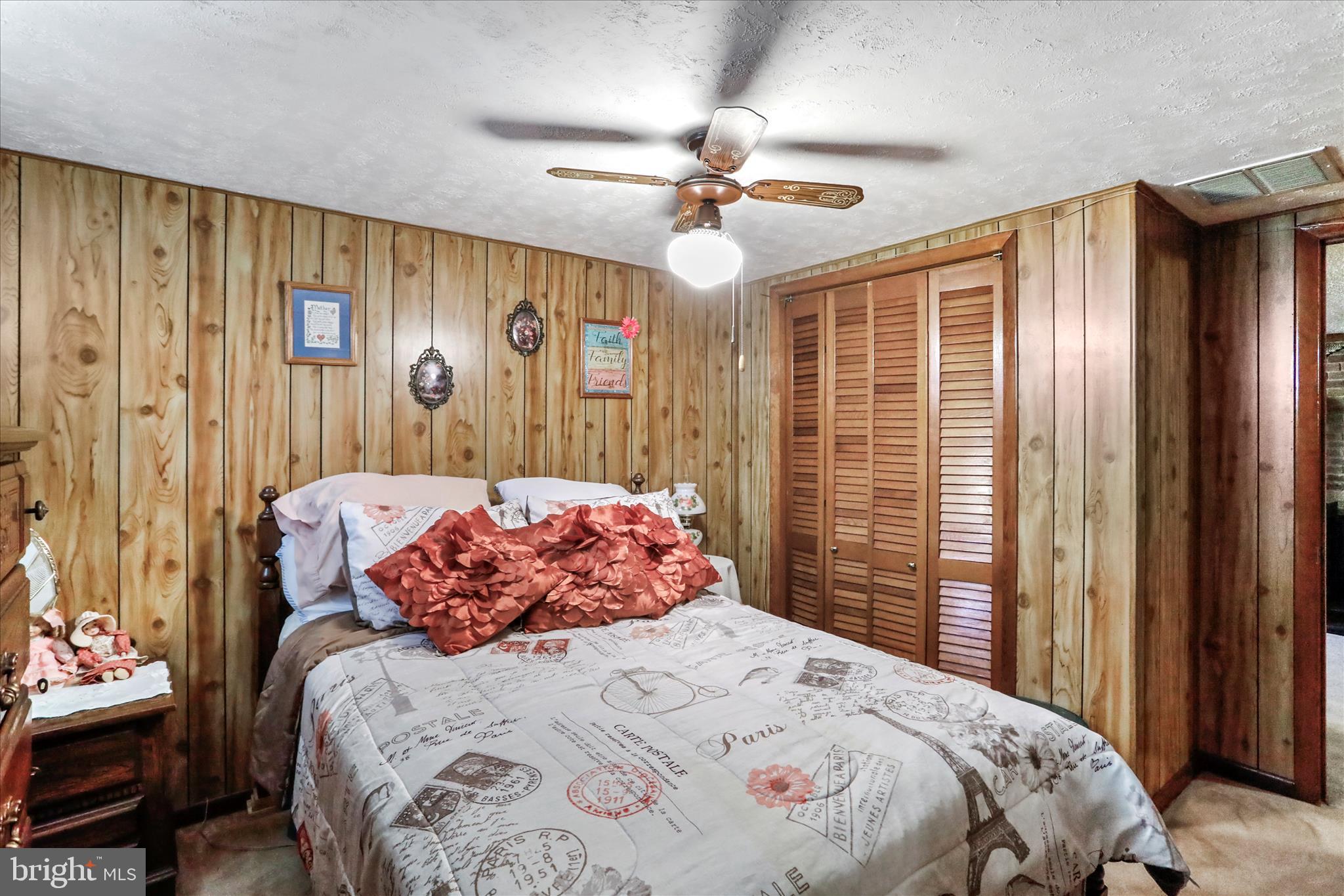 146 Miracle Drive Springfield, WV 26763 - Photo 14 of 40 a bedroom with a large bed and a chandelier