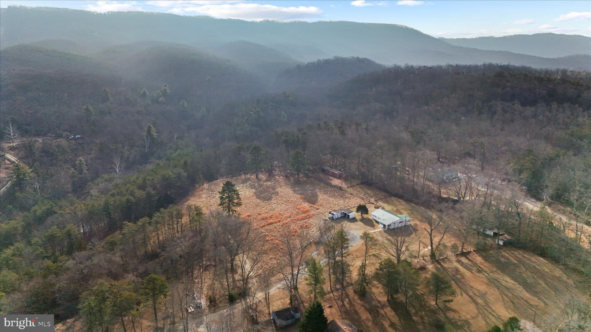 146 Miracle Drive Springfield, WV 26763 - Photo 2 of 40 a view of a dry yard with mountains in the background