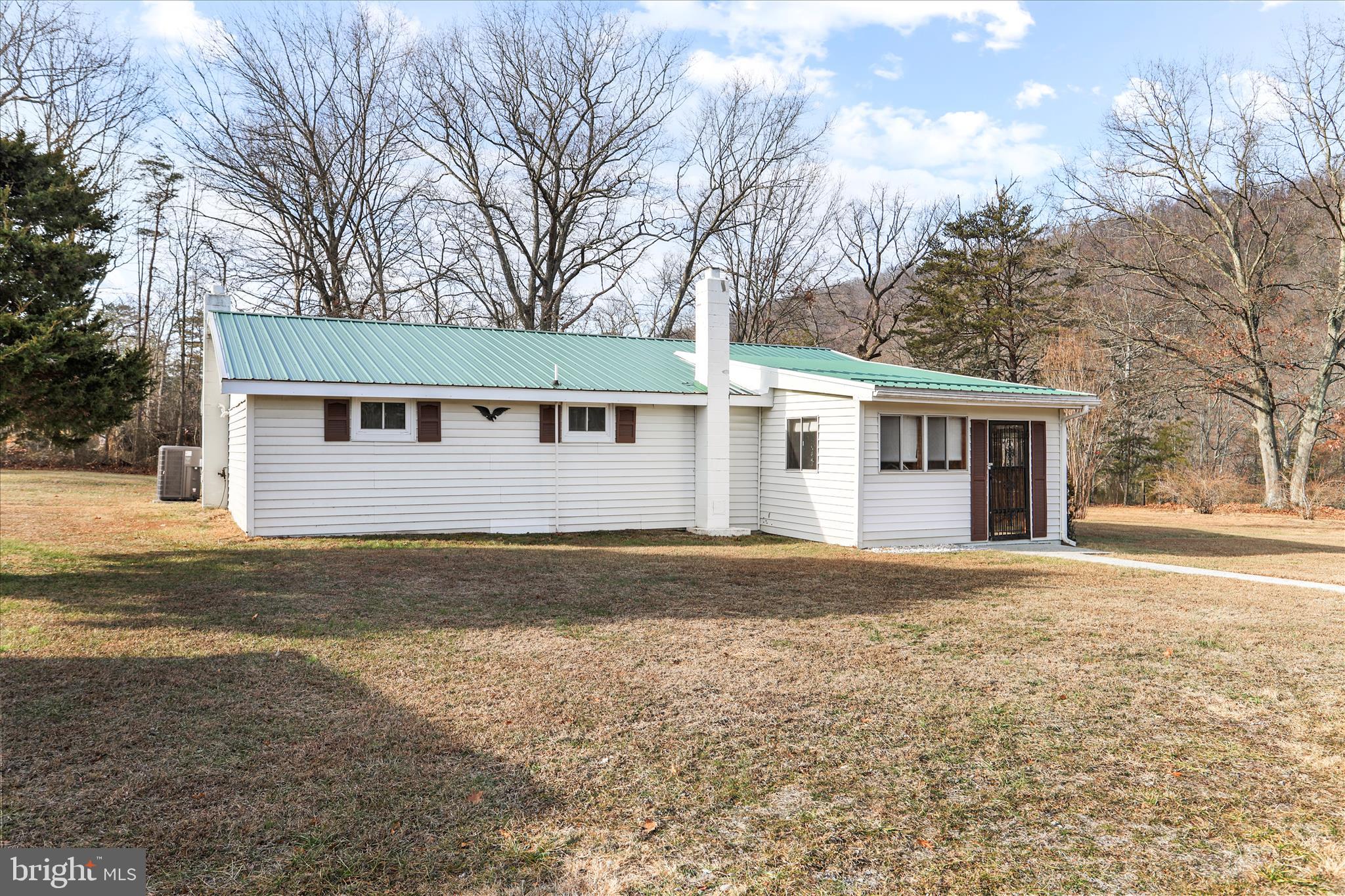 146 Miracle Drive Springfield, WV 26763 - Photo 26 of 40 a front view of a house with a yard and trees