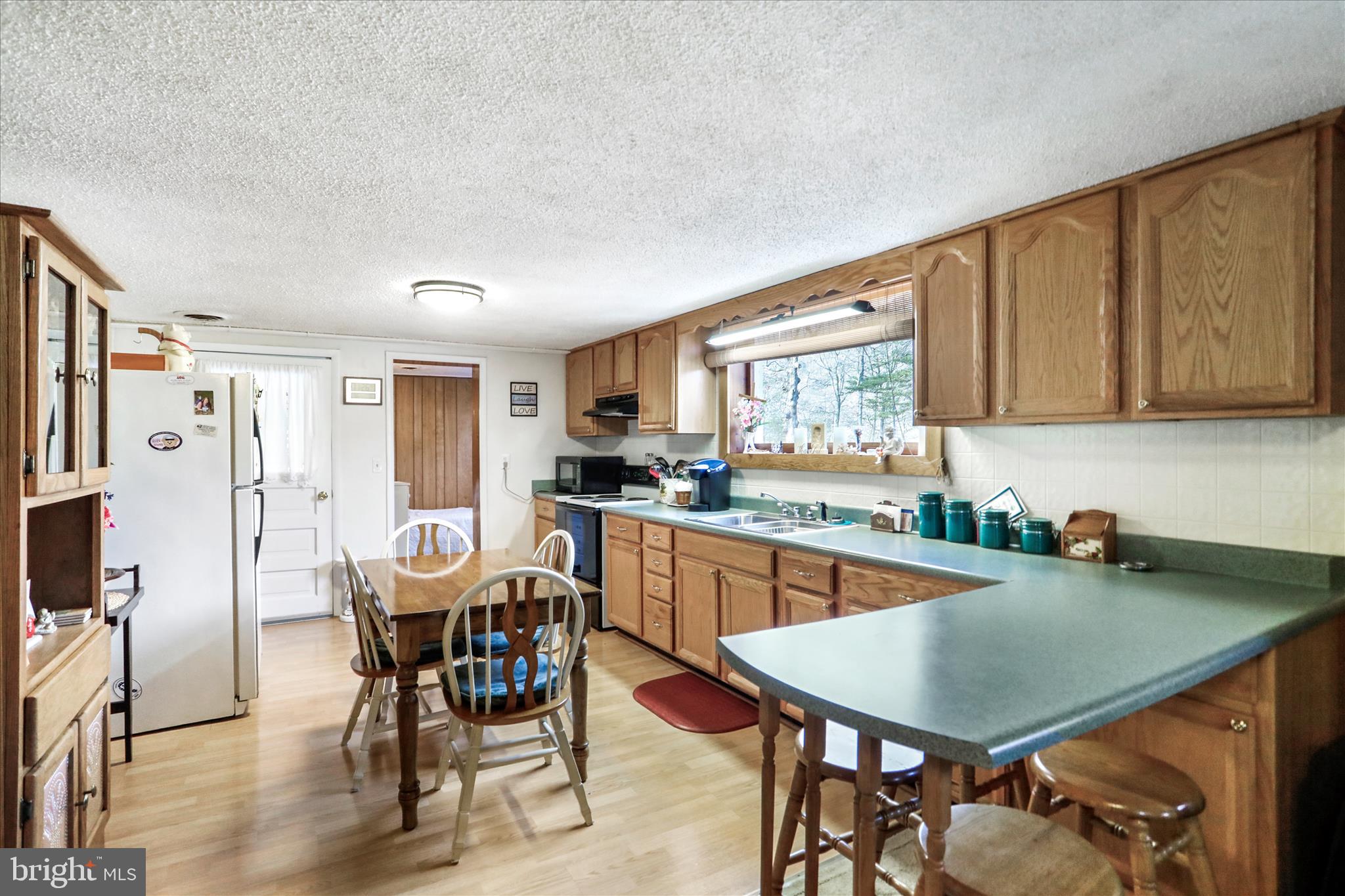 146 Miracle Drive Springfield, WV 26763 - Photo 7 of 40 a kitchen with stainless steel appliances granite countertop a table chairs sink and cabinets