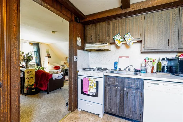 a kitchen with stainless steel appliances granite countertop a stove and cabinets