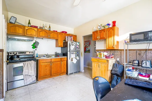 a kitchen with refrigerator and stove