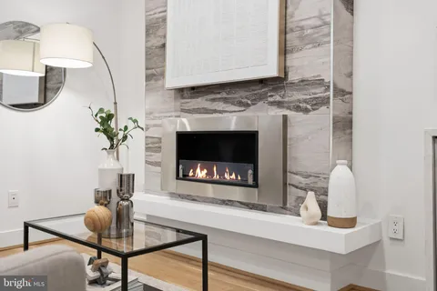 a living room with furniture a fireplace and a table