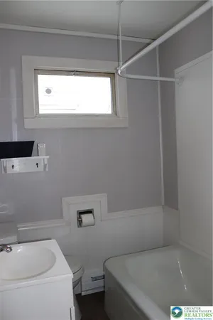a bathroom with a bathtub and window