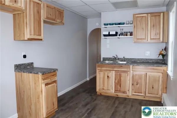 a kitchen with cabinets and window