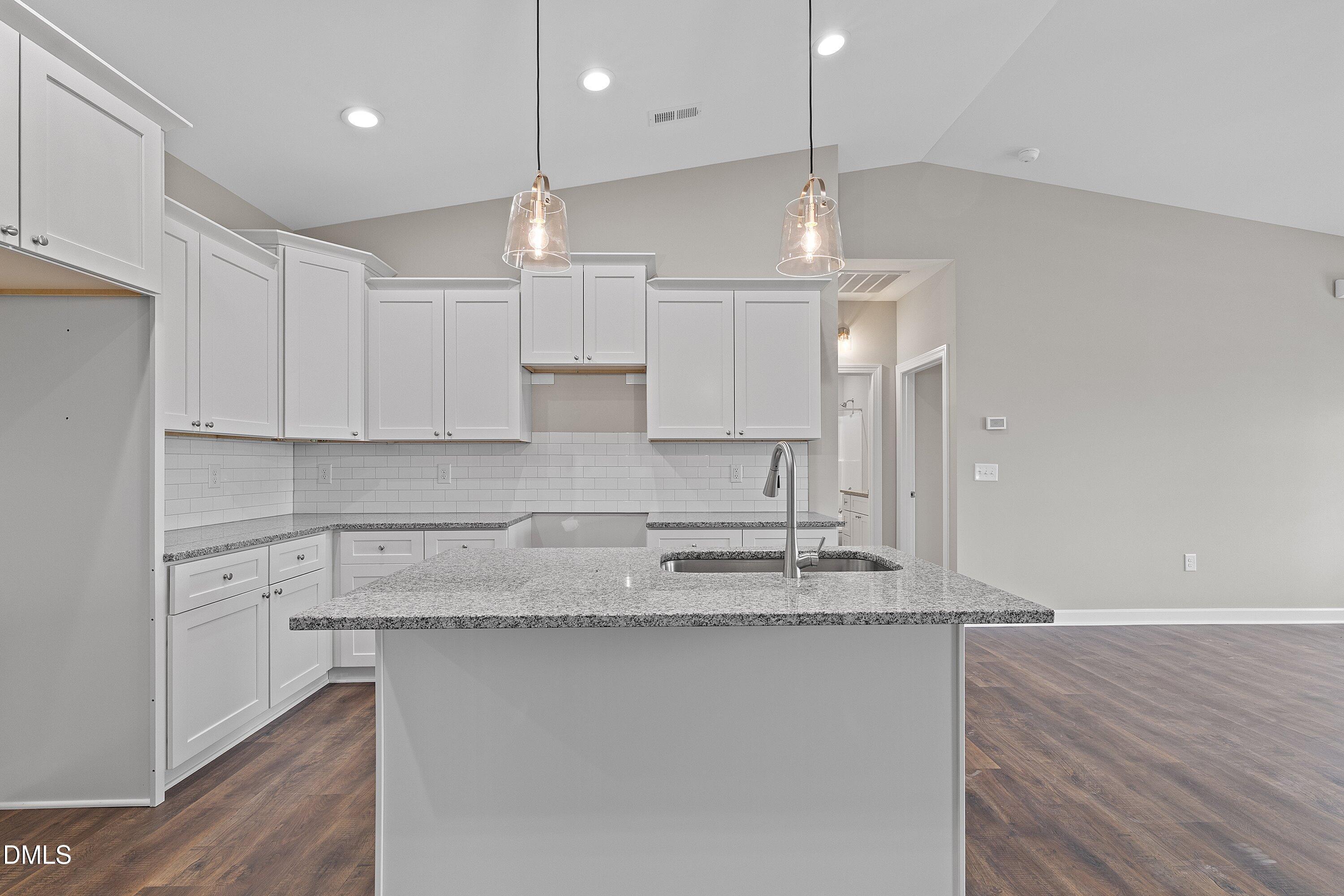 1117 Nor-Am Road Pikeville, NC 27863 - Photo 13 of 34 a kitchen with kitchen island white cabinets and stainless steel appliances
