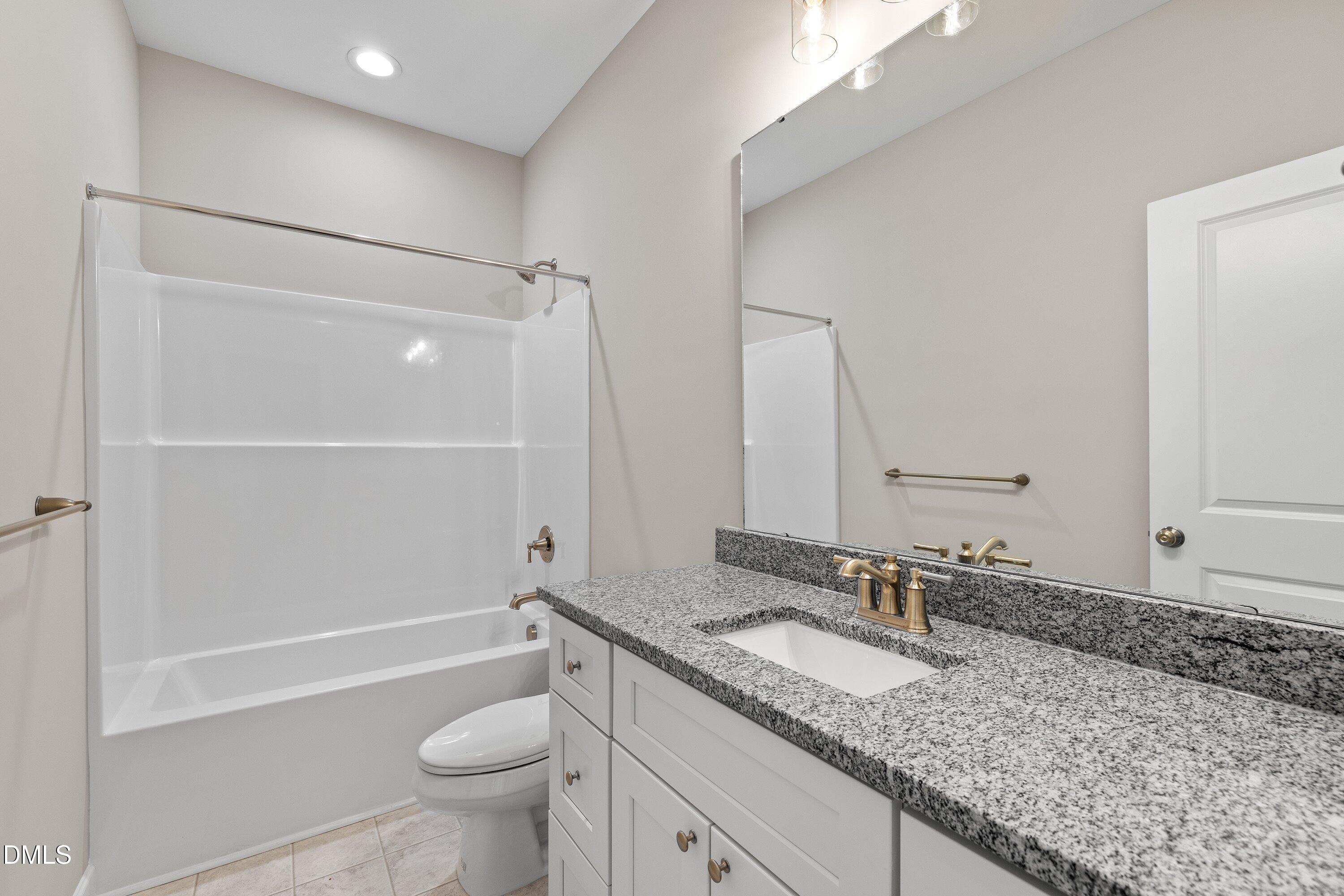 1117 Nor-Am Road Pikeville, NC 27863 - Photo 20 of 34 a bathroom with a granite countertop sink toilet and shower