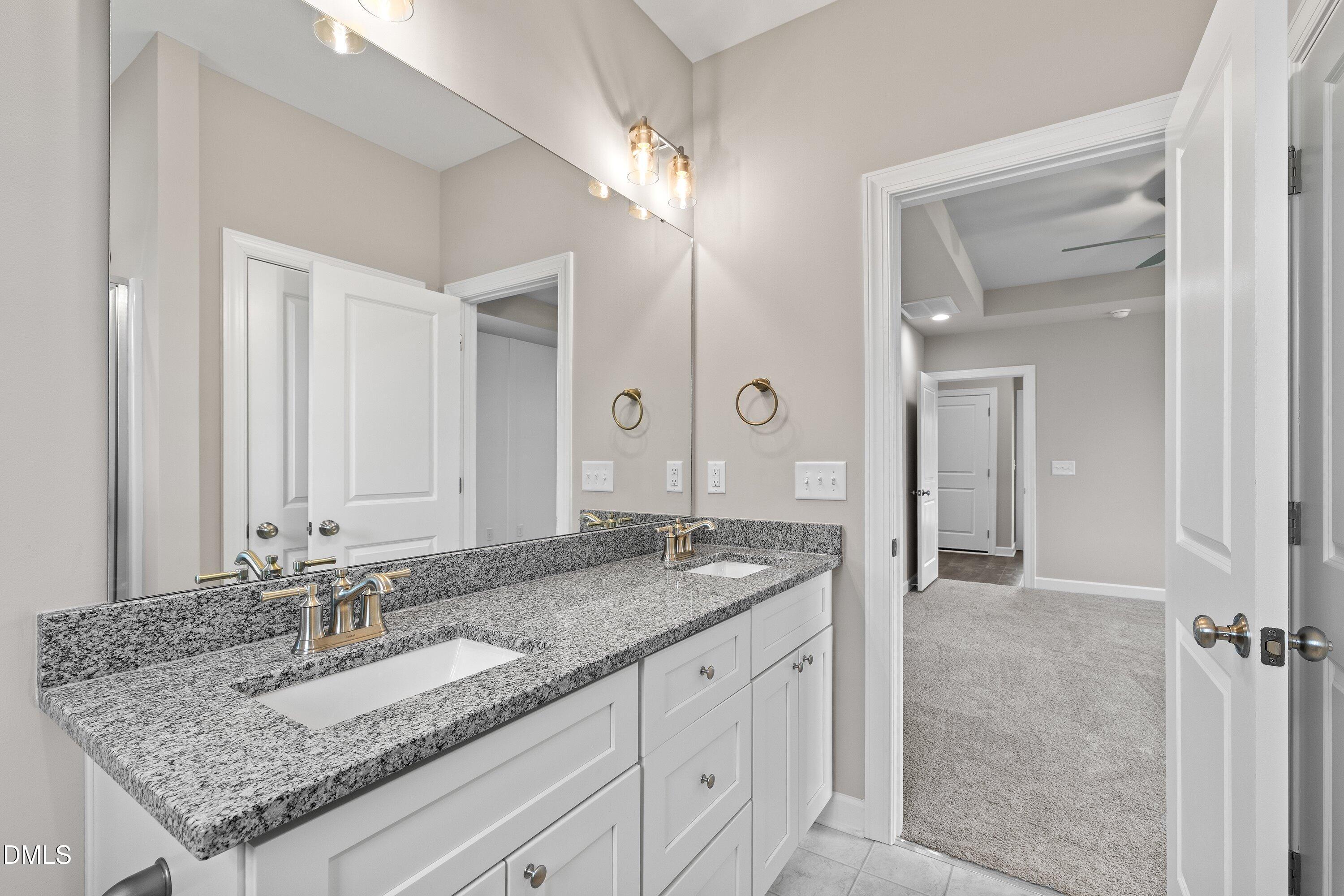 1117 Nor-Am Road Pikeville, NC 27863 - Photo 27 of 34 a bathroom with a granite countertop double vanity sink and a mirror