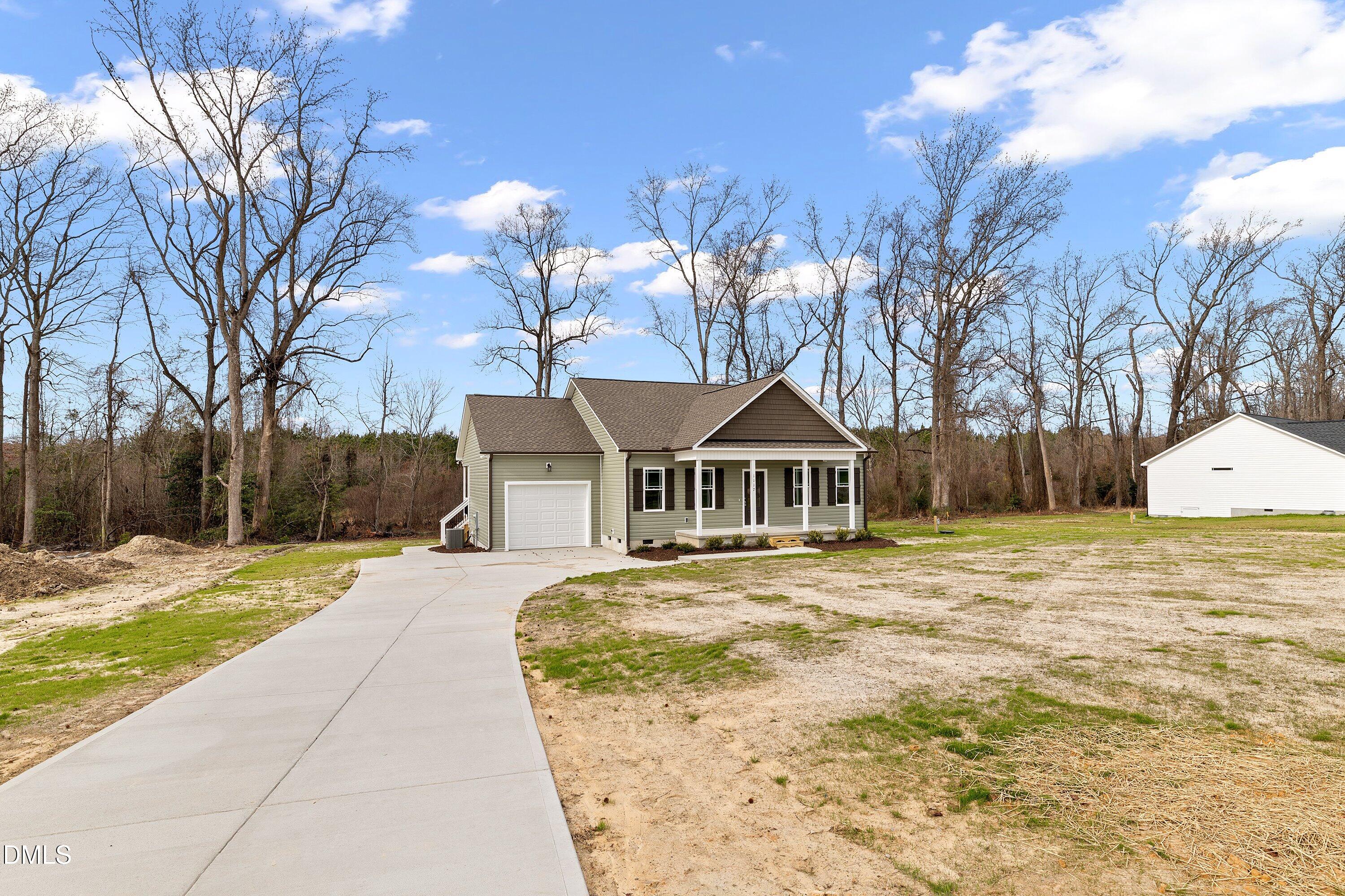 1117 Nor-Am Road Pikeville, NC 27863 - Photo 3 of 34 a front view of a house with a yard and trees