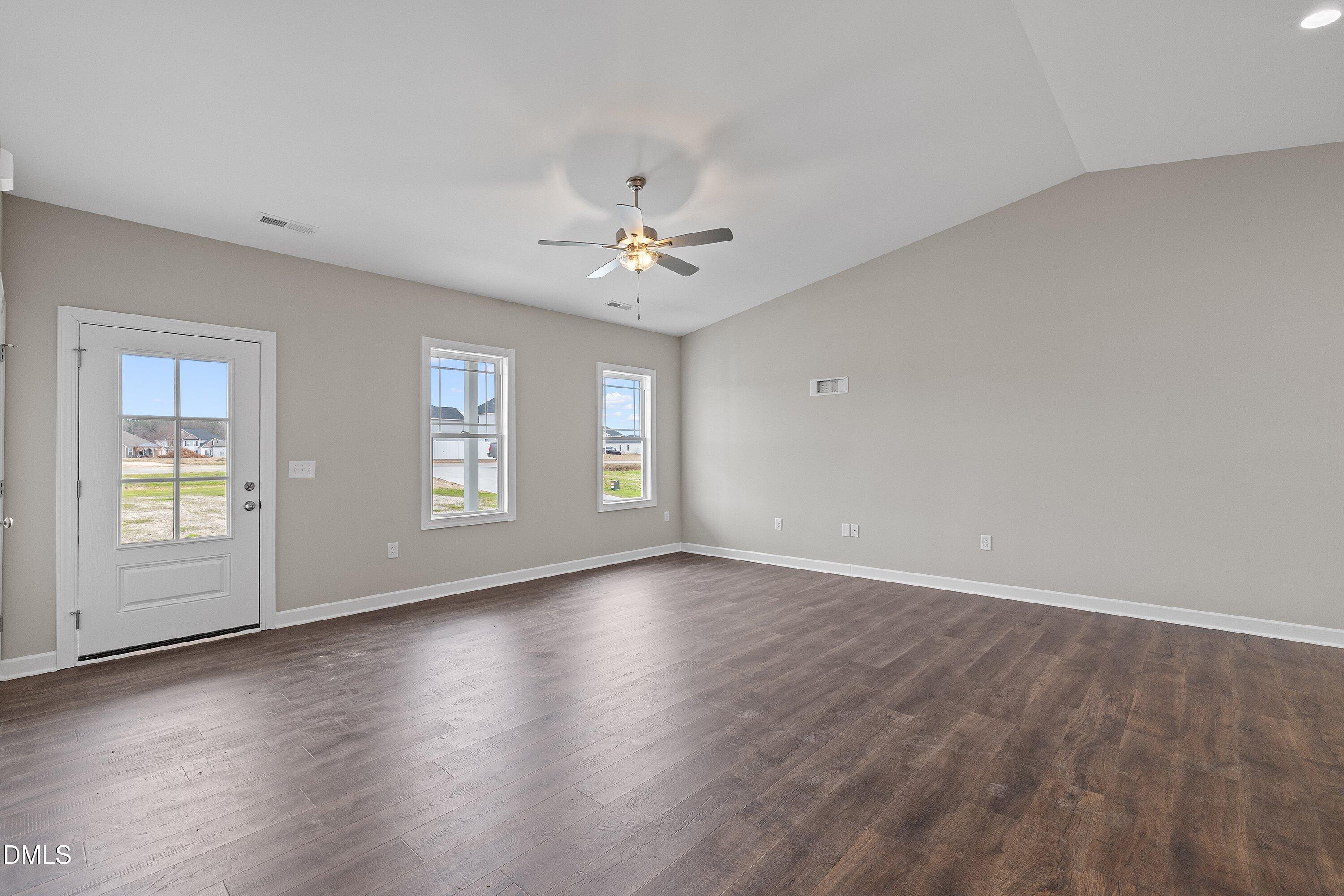 1117 Nor-Am Road Pikeville, NC 27863 - Photo 10 of 34 an empty room with wooden floor and windows