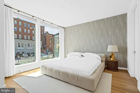 a bedroom with a bed and a night stand