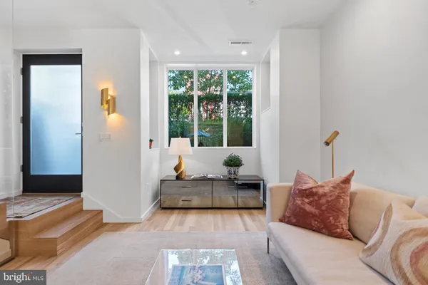 a living room with furniture and large windows