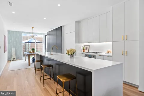 a kitchen with a sink cabinets and wooden floor