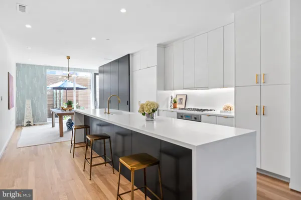 a kitchen with a sink cabinets and wooden floor