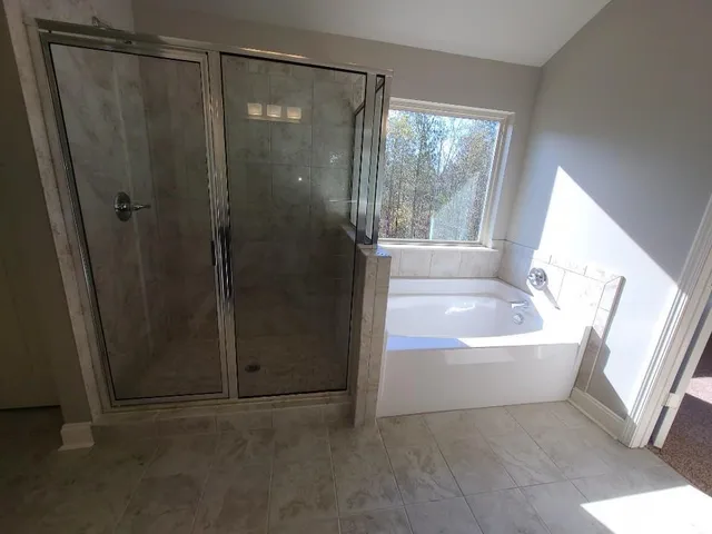 a bathroom with a bathtub and shower