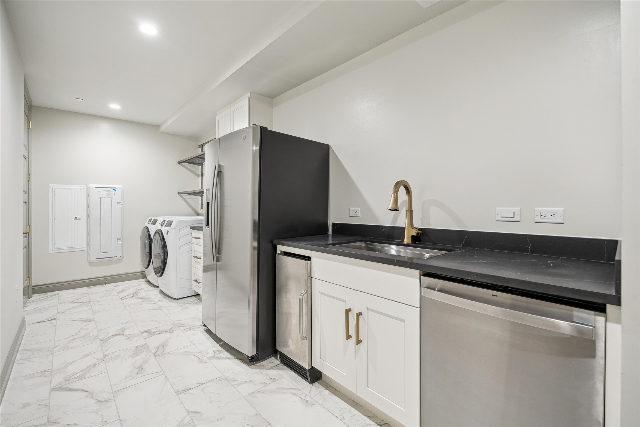 1717 Bissonnet Street, Unit 1802 Houston, TX 77005 - Photo 31 of 46 Expansive service kitchen with second dishwasher, second refrigerator, separate ice maker, sink, Quartz counters, full size washer and dryer.