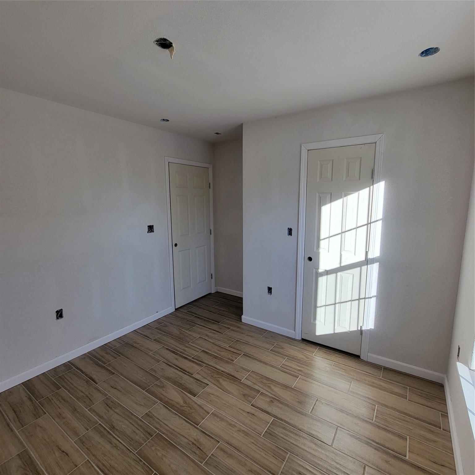 3370 Lorilee Street Beaumont, TX 77708 - Photo 10 of 11 a view of an empty room with wooden floor and a window
