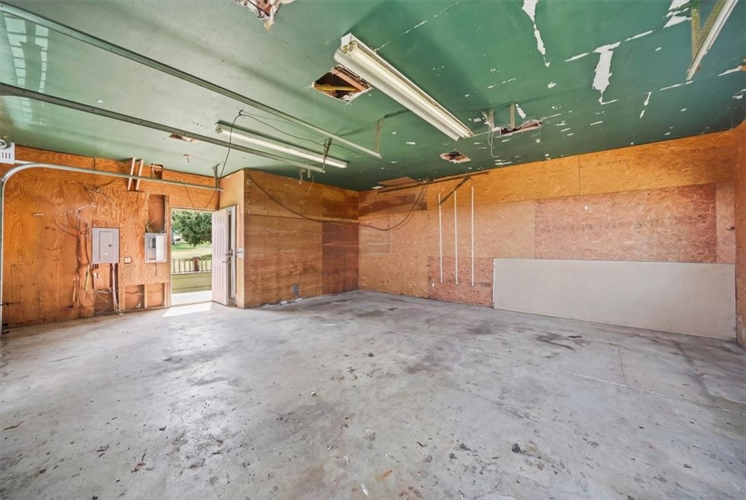 32 Equestrian Way Cranston, RI 02921 - Photo 32 of 50 The first floor of this substantial outbuilding delivers extraordinary flexibility, pairing an approximately 720-square-foot garage with two tall roll-up doors and an enormous finished multipurpose area in the back.