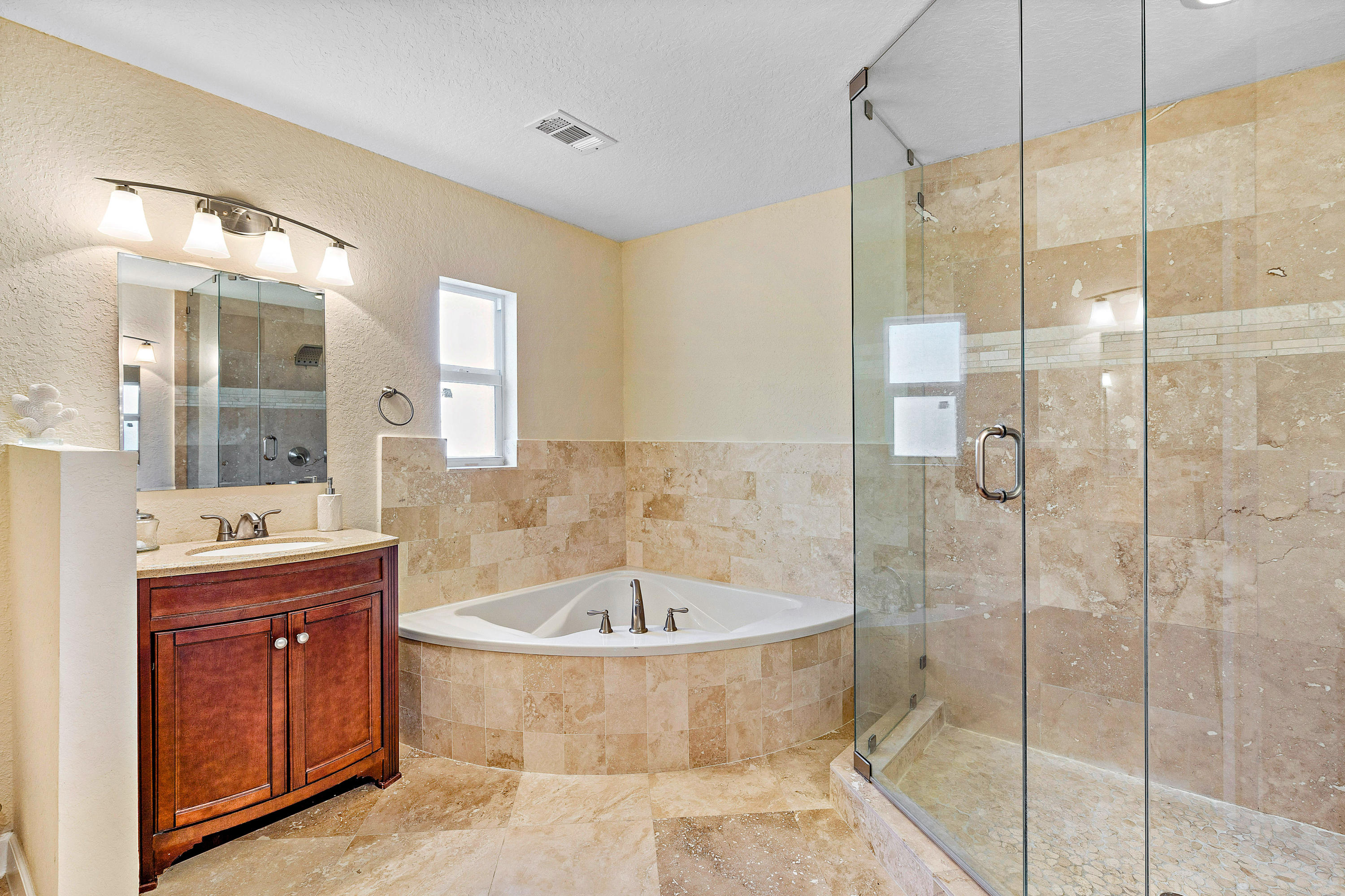 208 Bamboo Road Palm Beach Shores, FL 33404 - Photo 14 of 30 a bathroom with a tub a sink shower and mirror