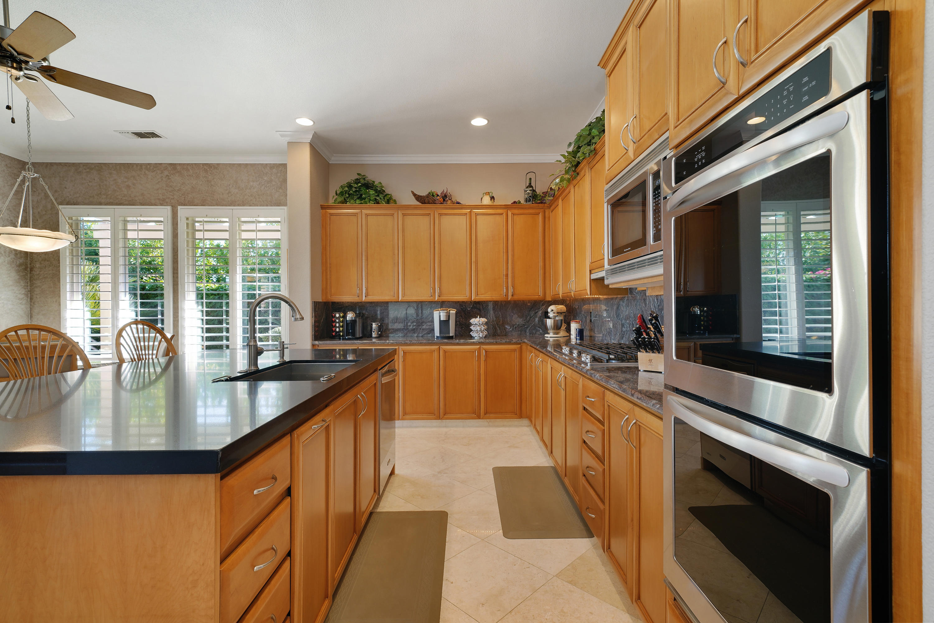 4 Vía Verde Rancho Mirage, CA 92270 - Photo 19 of 63 a large kitchen with kitchen island granite countertop a large window and a counter space