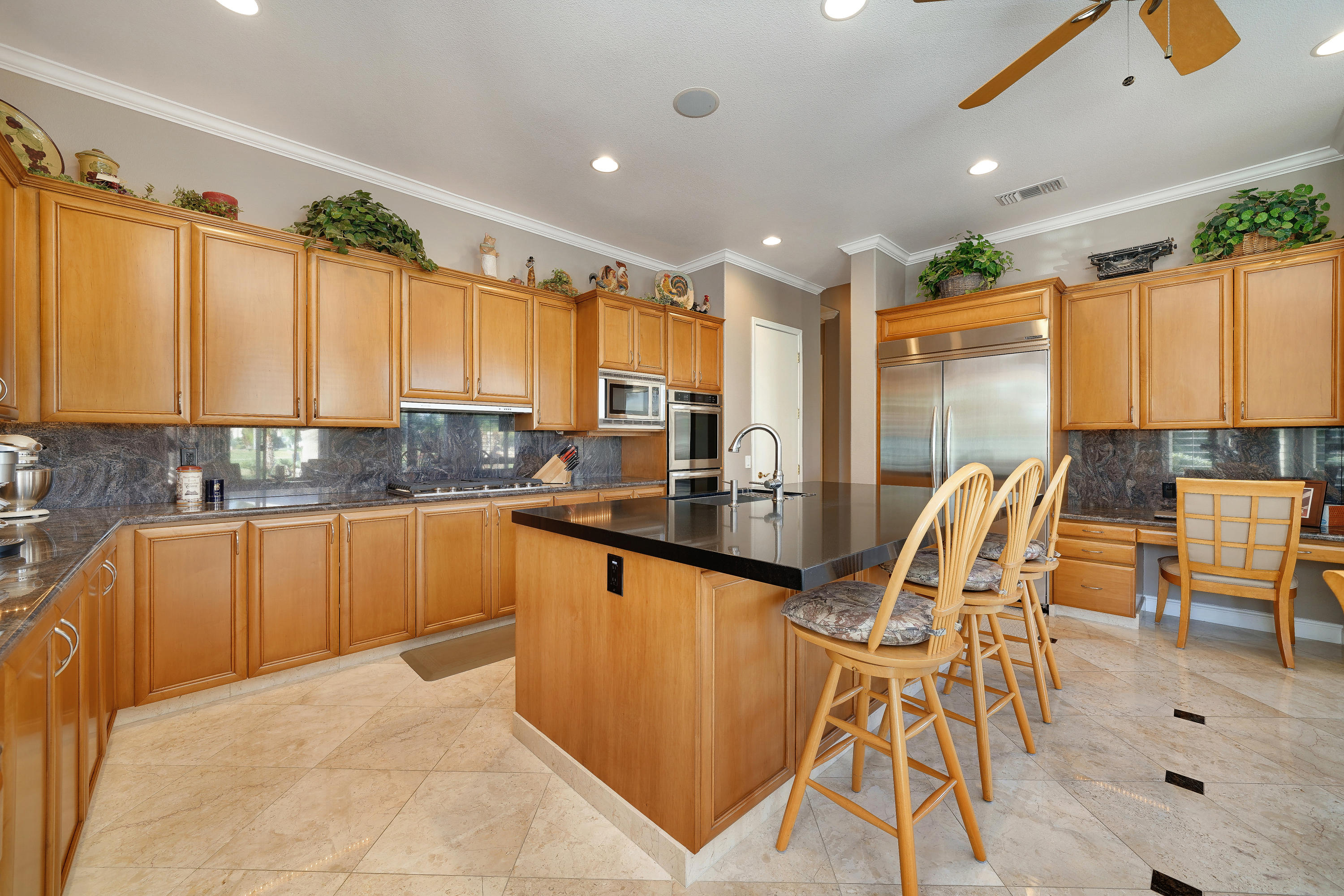4 Vía Verde Rancho Mirage, CA 92270 - Photo 21 of 63 a open kitchen with stainless steel appliances granite countertop a stove top oven a sink a dining table and chairs