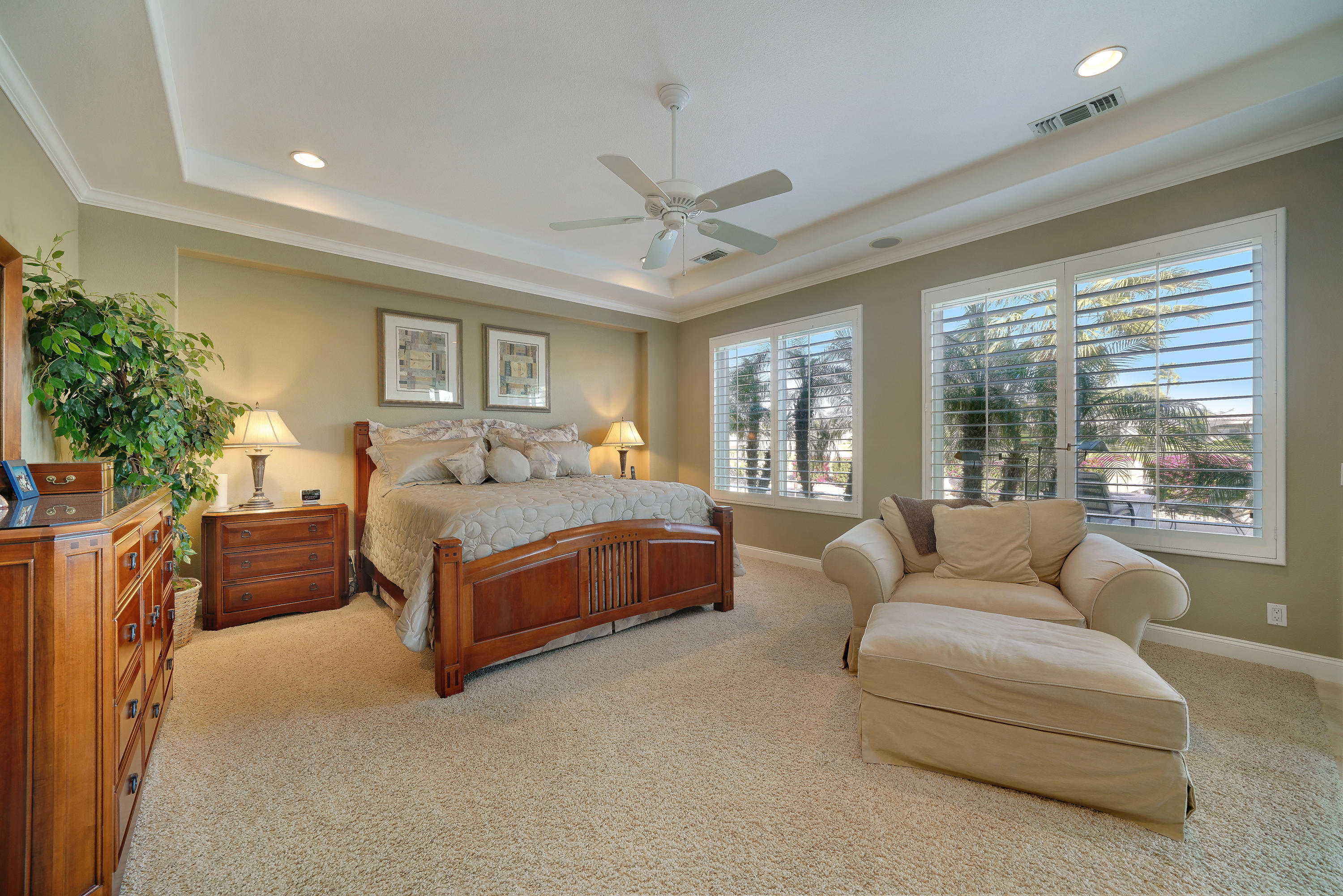 4 Vía Verde Rancho Mirage, CA 92270 - Photo 22 of 63 a bedroom with a large bed couch and windows