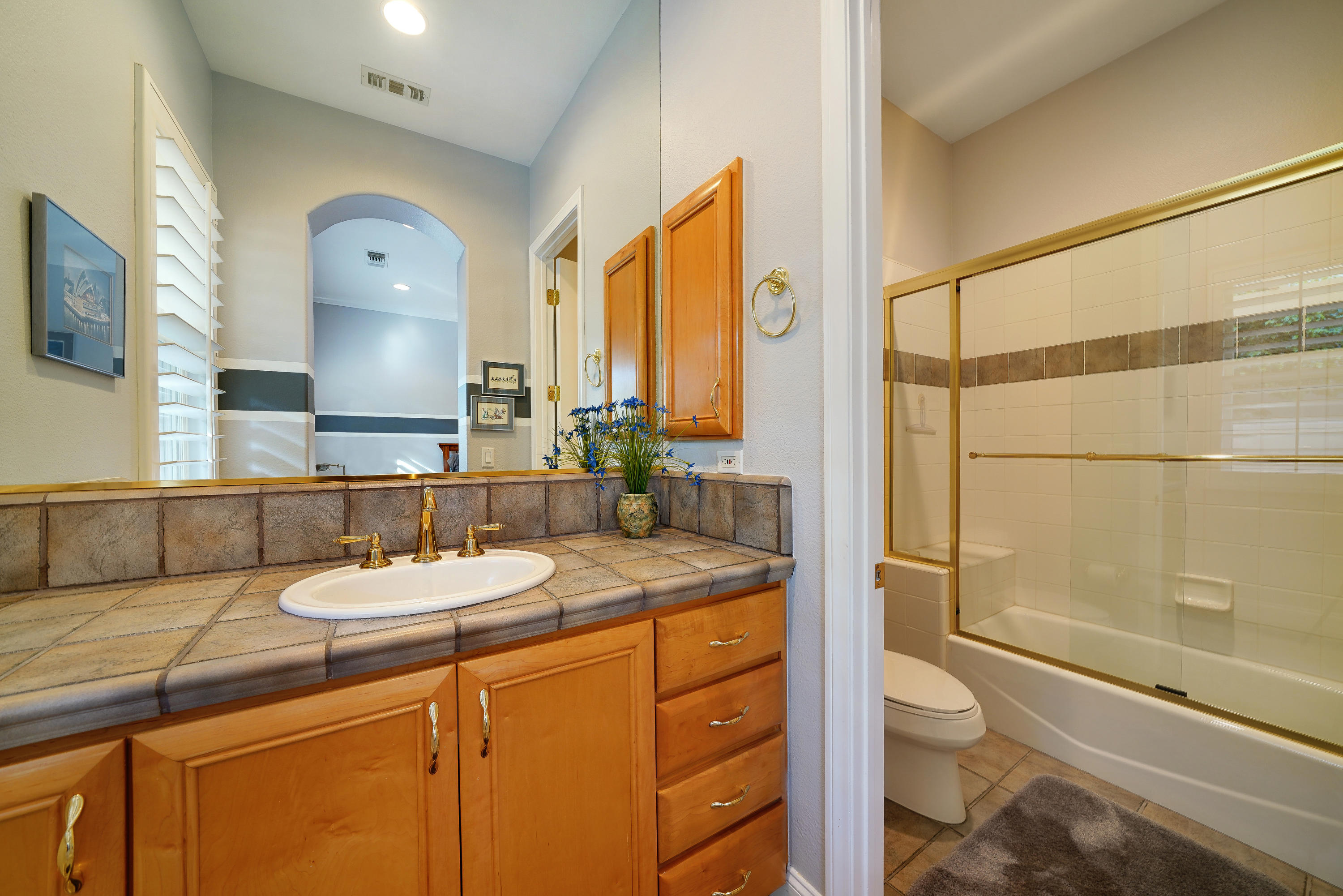 4 Vía Verde Rancho Mirage, CA 92270 - Photo 32 of 63 a bathroom with a granite countertop sink toilet and shower