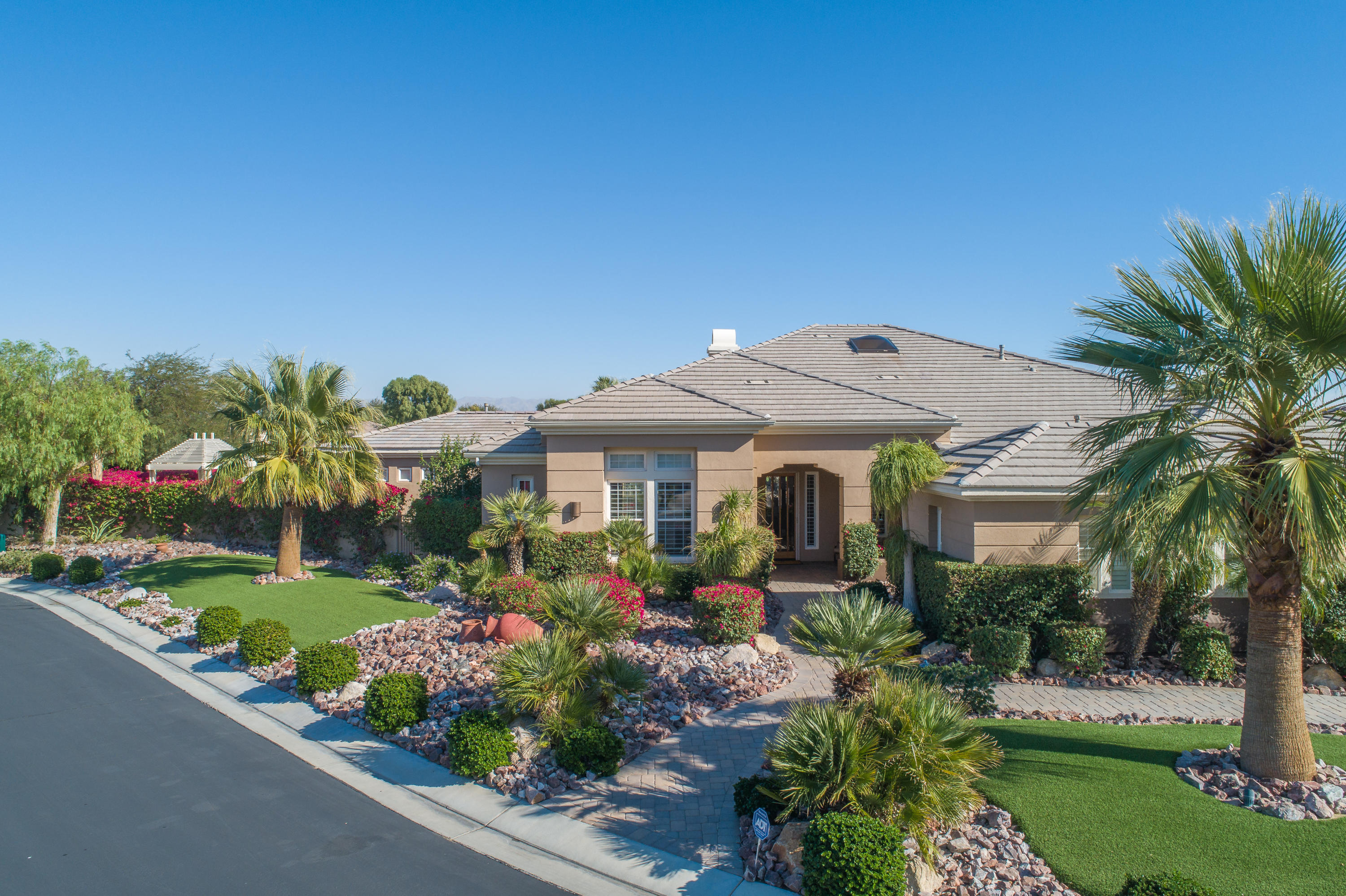 4 Vía Verde Rancho Mirage, CA 92270 - Photo 36 of 63 a front view of a house with a garden