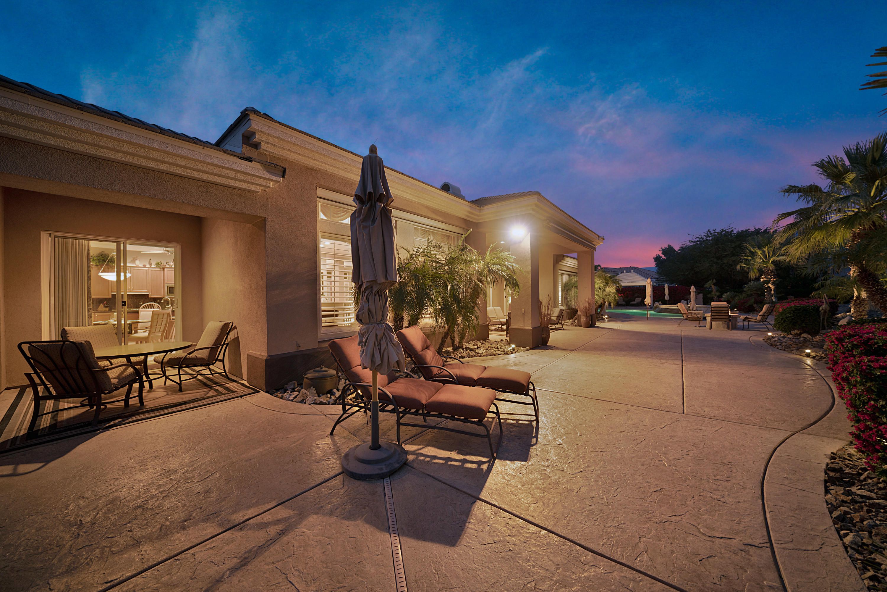 4 Vía Verde Rancho Mirage, CA 92270 - Photo 62 of 63 a view of a patio with table and chairs with plants and wooden fence