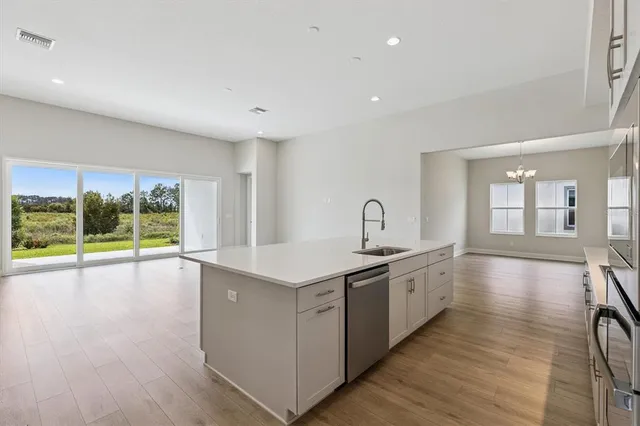 a view of a kitchen with a sink and wooden floor
