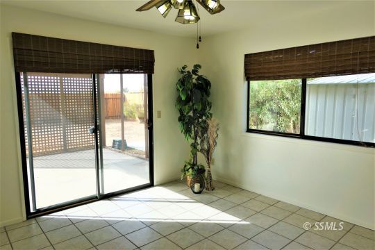 337 Larkspur Street Ridgecrest, CA 93555 - Photo 9 of 38 a view of empty room with wooden floor and fan