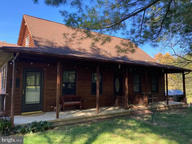 a view of a house with backyard porch and sitting area