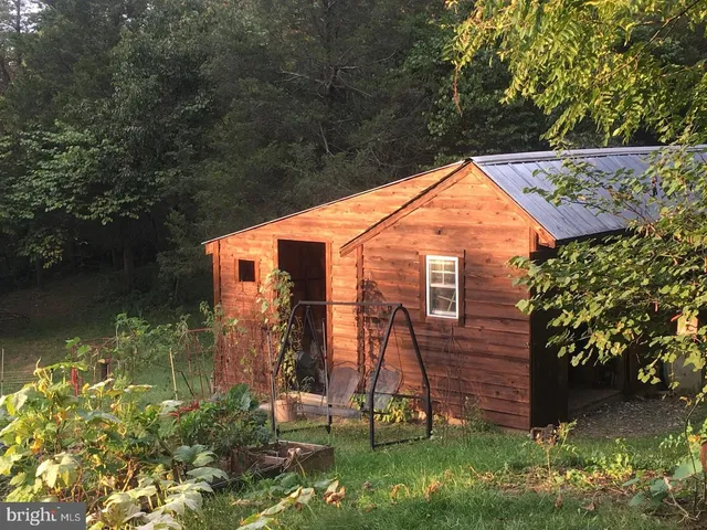 a view of backyard with garden and deck