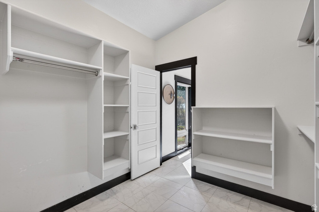 145 Carnesecca Court Mapleton, UT 84664 - Photo 53 of 109 Walk in closet with light marble finish flooring