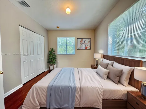 a bedroom with a bed and a window