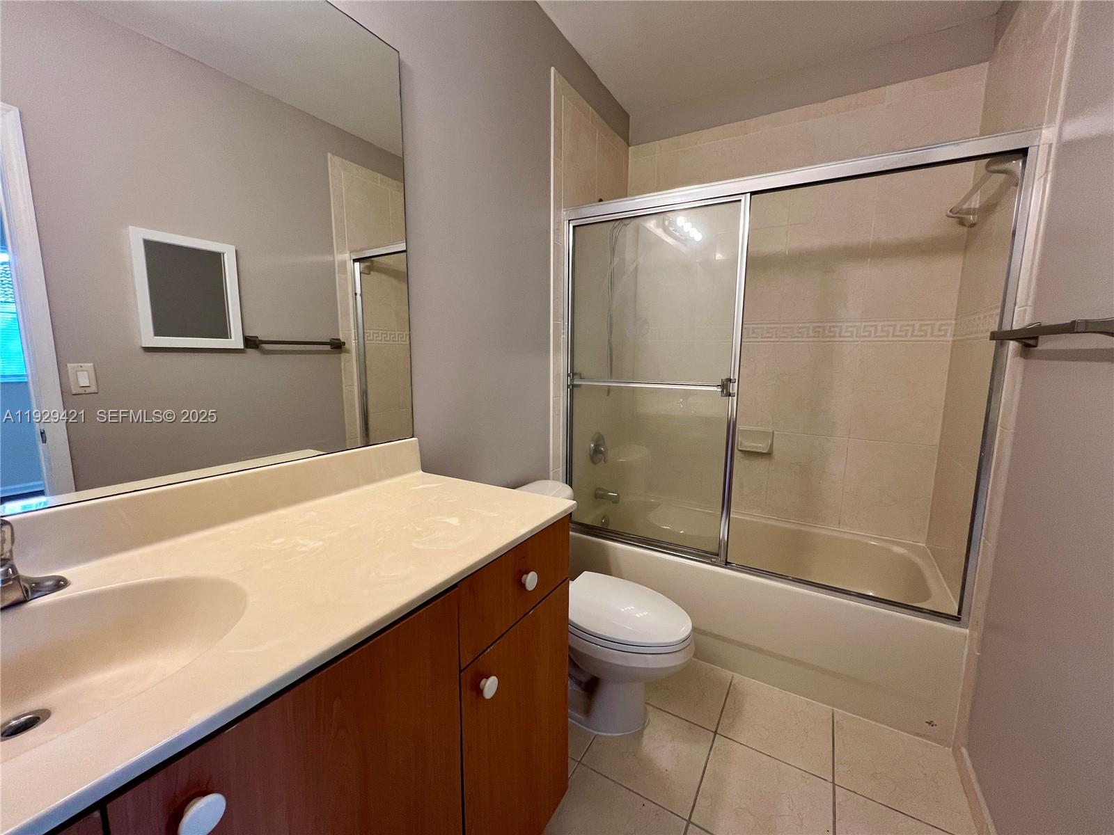 8208 Southwest 29th Street, Unit 101 Miramar, FL 33025 - Photo 13 of 19 a bathroom with a sink a toilet and shower