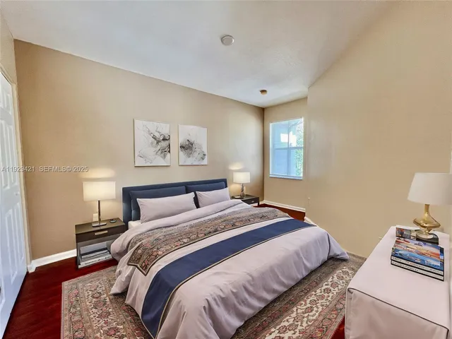 a bedroom with bed and a window