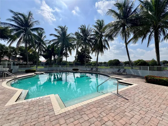 a view of a swimming pool with a table and chairs