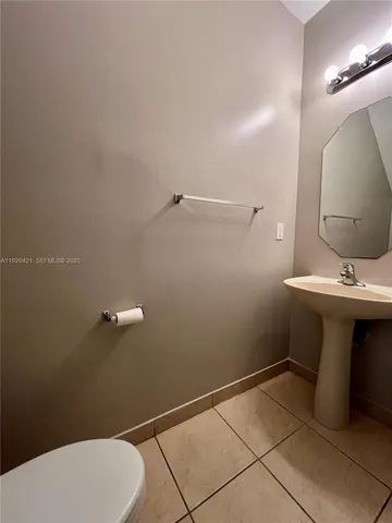 a bathroom with a sink mirror and toilet