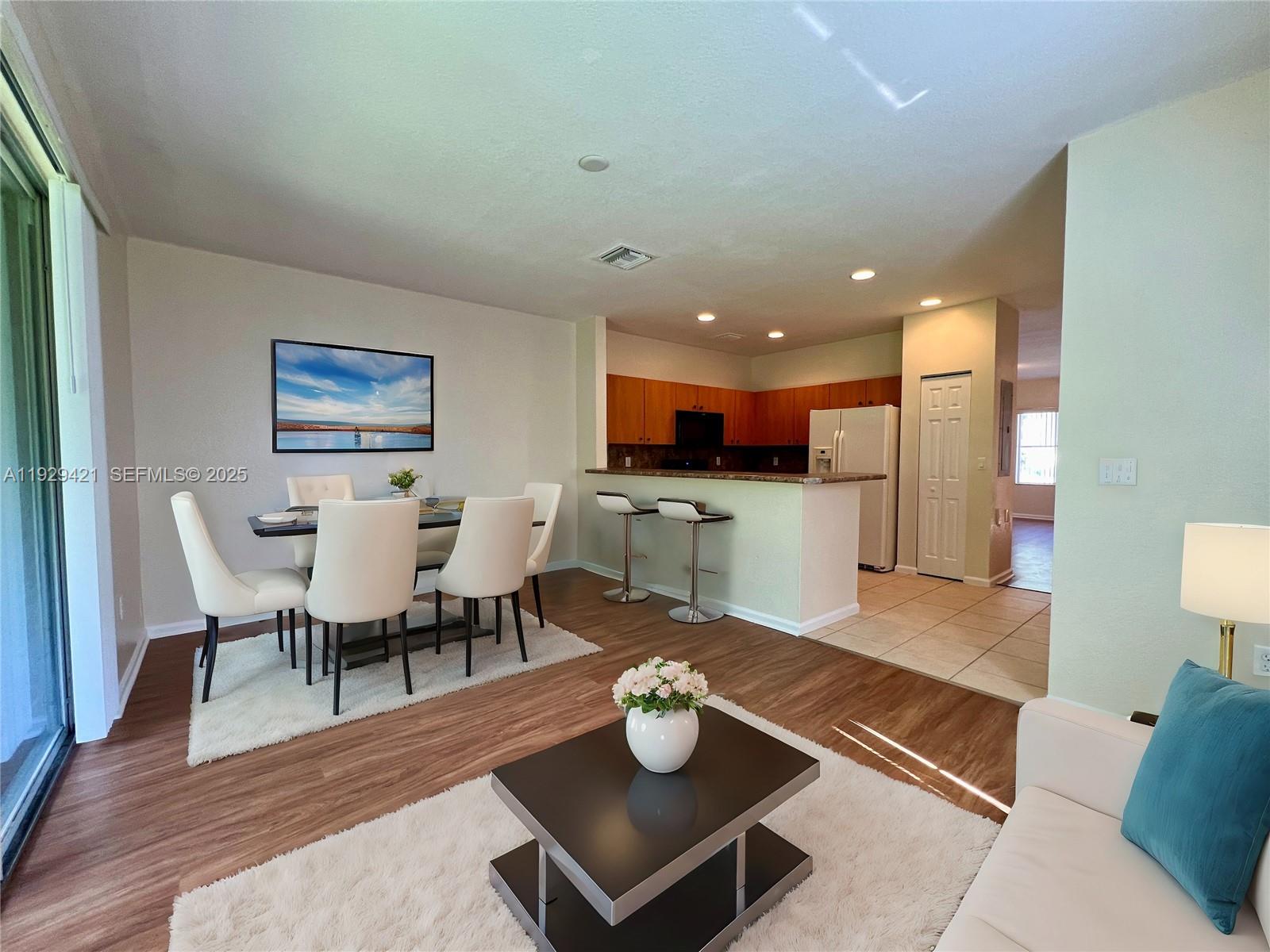 8208 Southwest 29th Street, Unit 101 Miramar, FL 33025 - Photo 6 of 19 a living room with lots of furniture and kitchen view