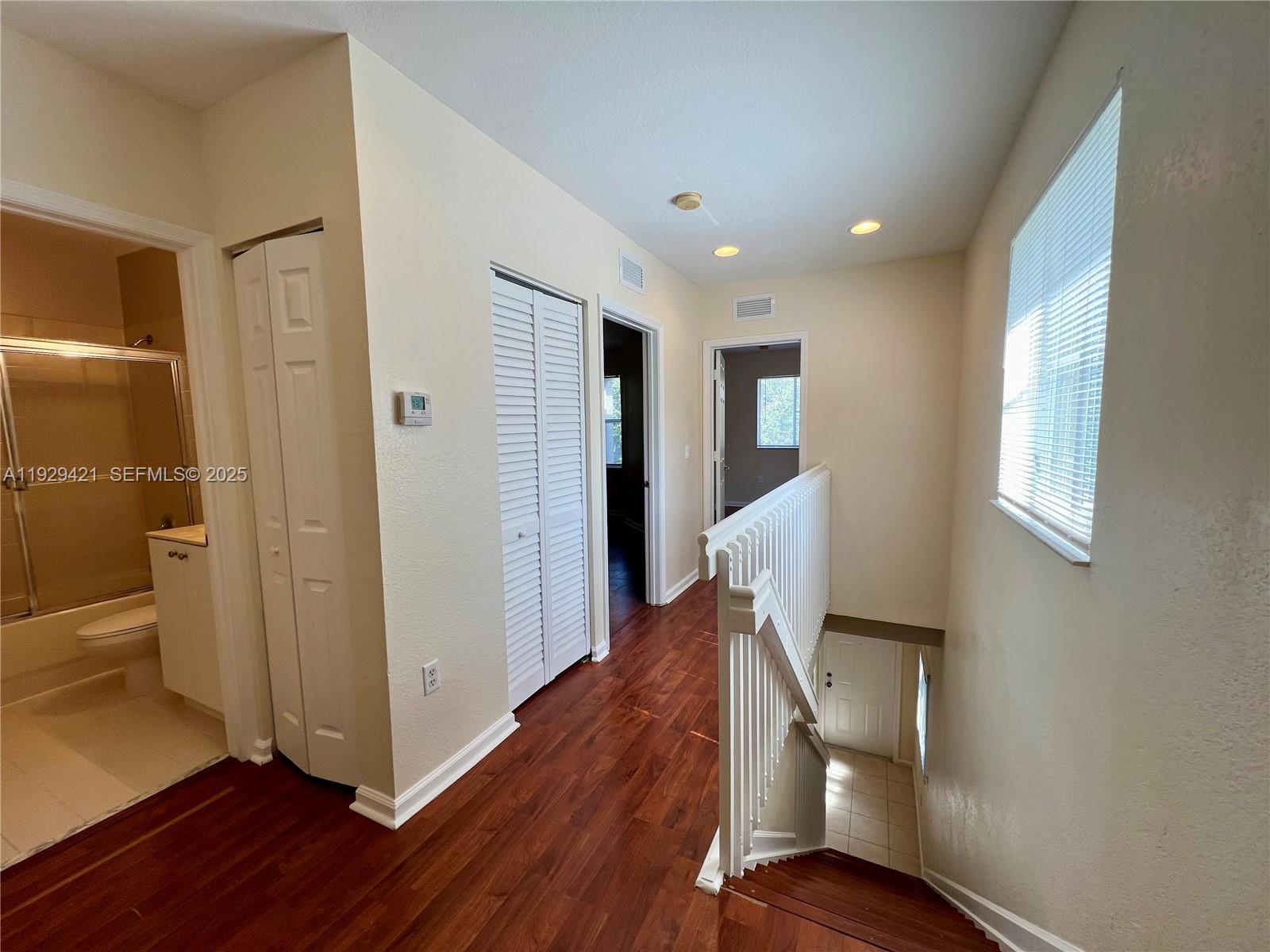 8208 Southwest 29th Street, Unit 101 Miramar, FL 33025 - Photo 8 of 19 a view of a hallway with wooden floor and staircase