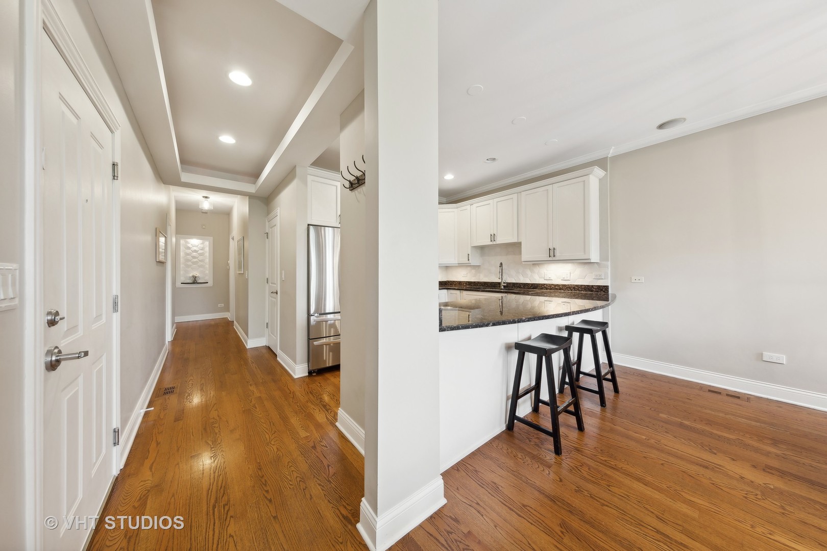 2136 West Division Street, Unit 3 Chicago, IL 60622 - Photo 12 of 37 a view of a hallway with wooden floor and chairs