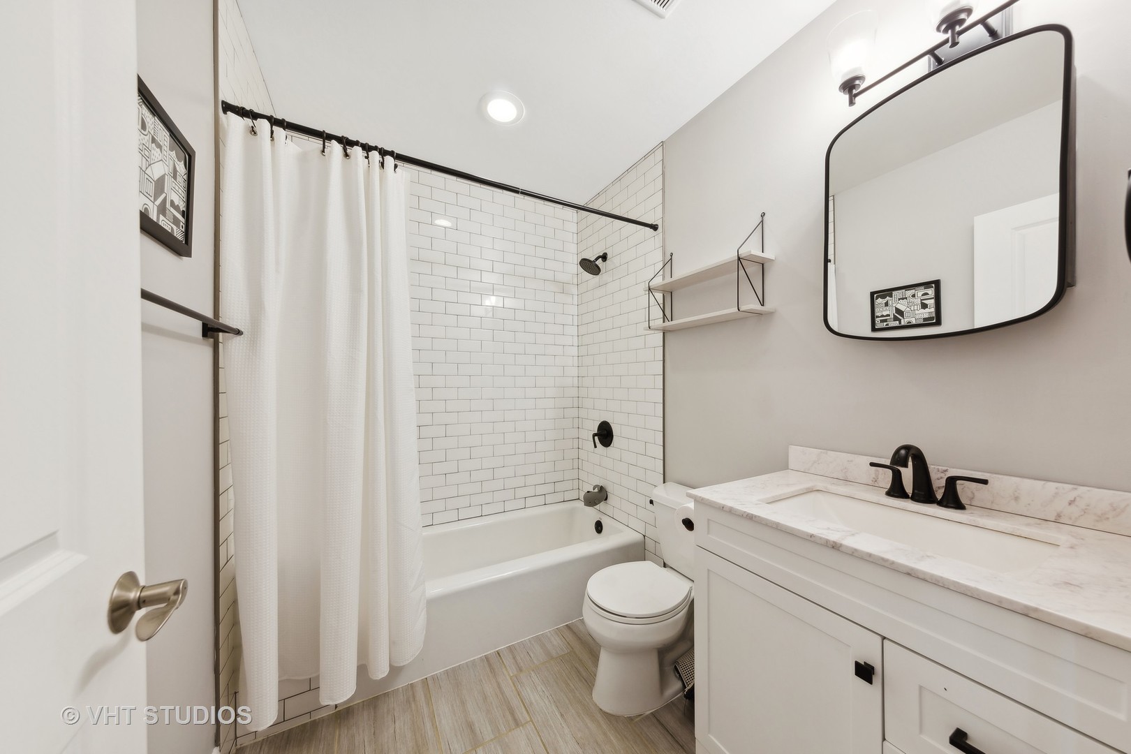 2136 West Division Street, Unit 3 Chicago, IL 60622 - Photo 26 of 37 a bathroom with a sink a mirror a toilet and a bathtub