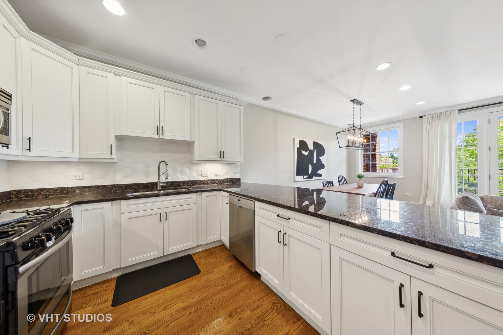 2136 West Division Street, Unit 3 Chicago, IL 60622 - Photo 10 of 37 a kitchen with granite countertop white cabinets and white appliances