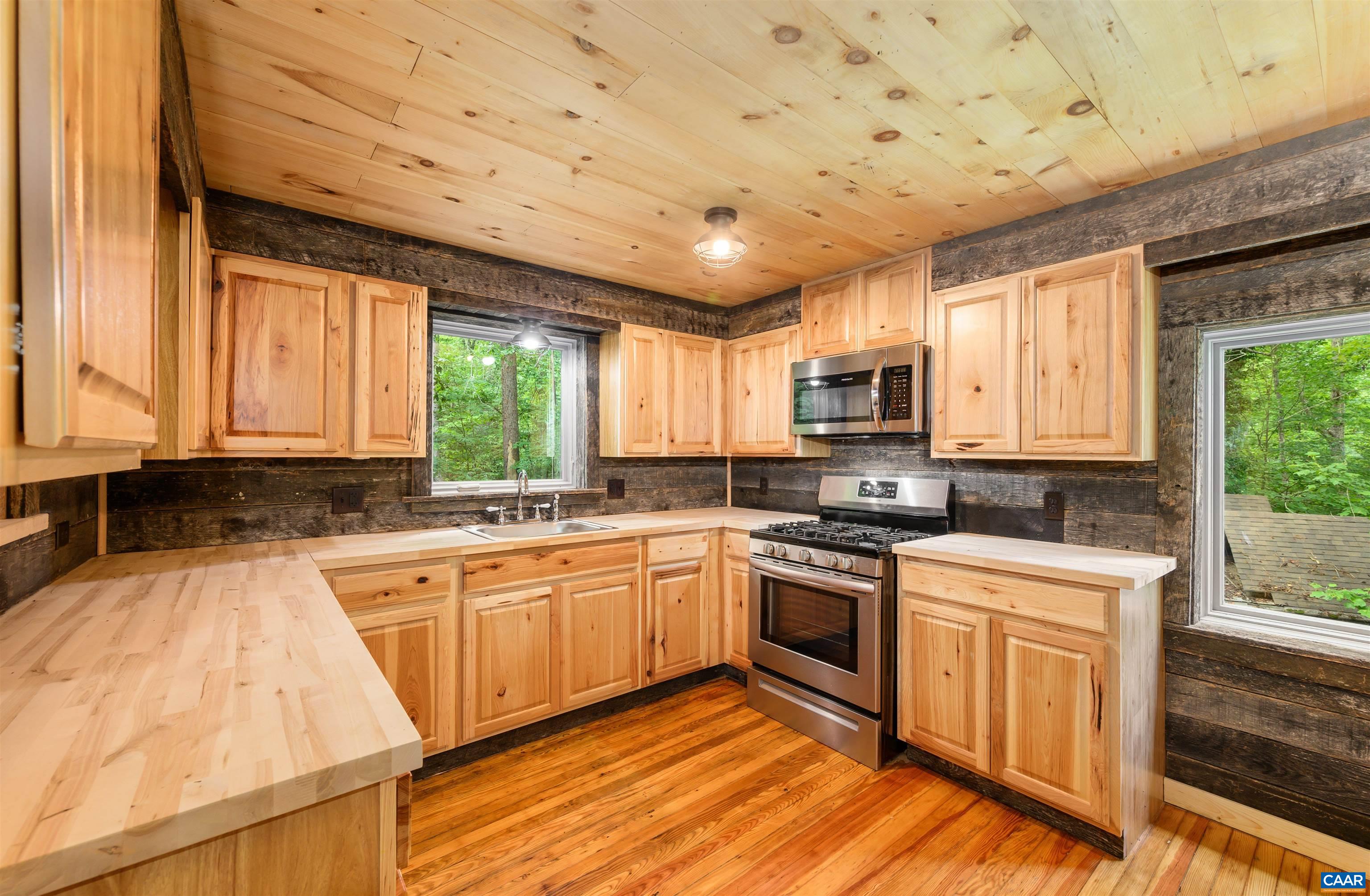 3882 Firehouse Road Howardsville, VA 24562 - Photo 12 of 75 a kitchen with a stove sink and microwave