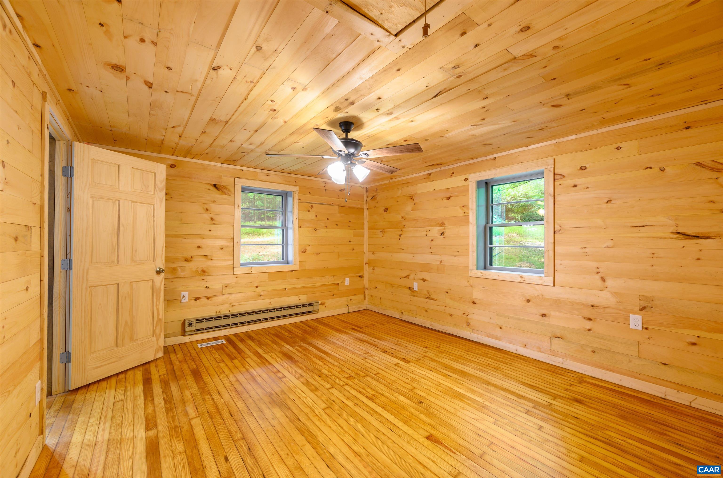 3882 Firehouse Road Howardsville, VA 24562 - Photo 16 of 75 a view of an empty room with a window and wooden floor