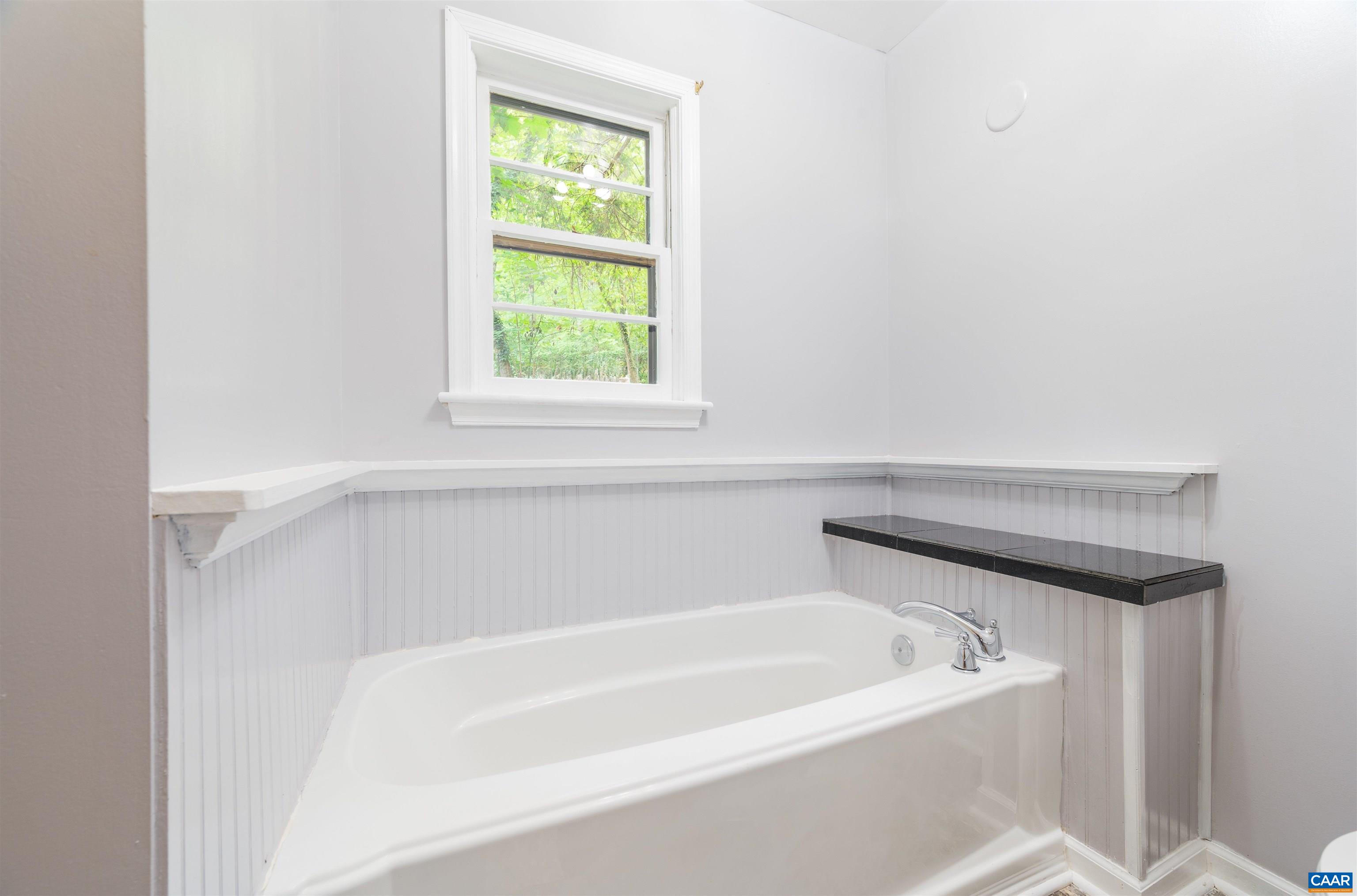 3882 Firehouse Road Howardsville, VA 24562 - Photo 22 of 75 a white bath tub sitting next to a window