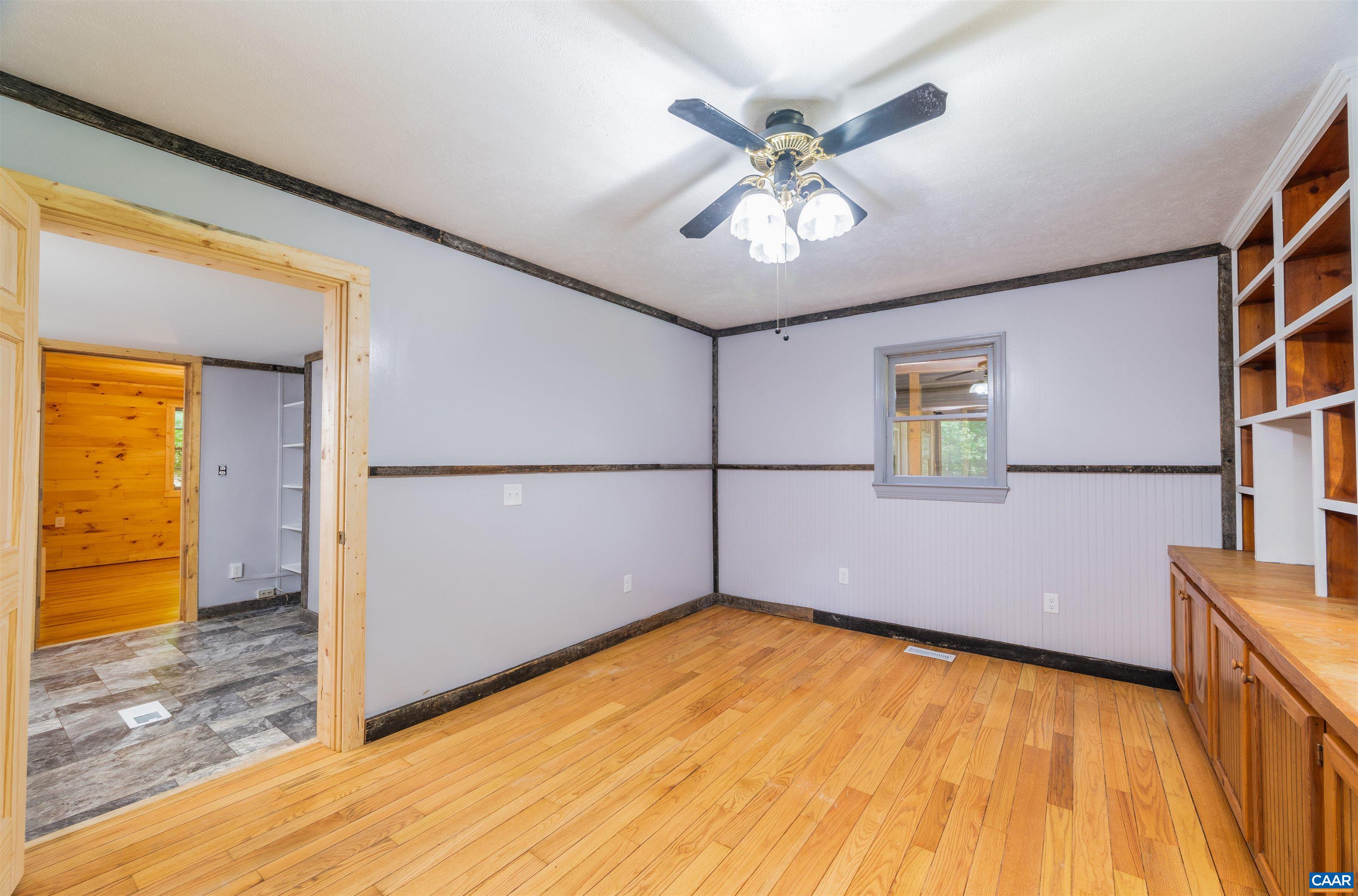 3882 Firehouse Road Howardsville, VA 24562 - Photo 25 of 75 a view of empty room with wooden floor and fan
