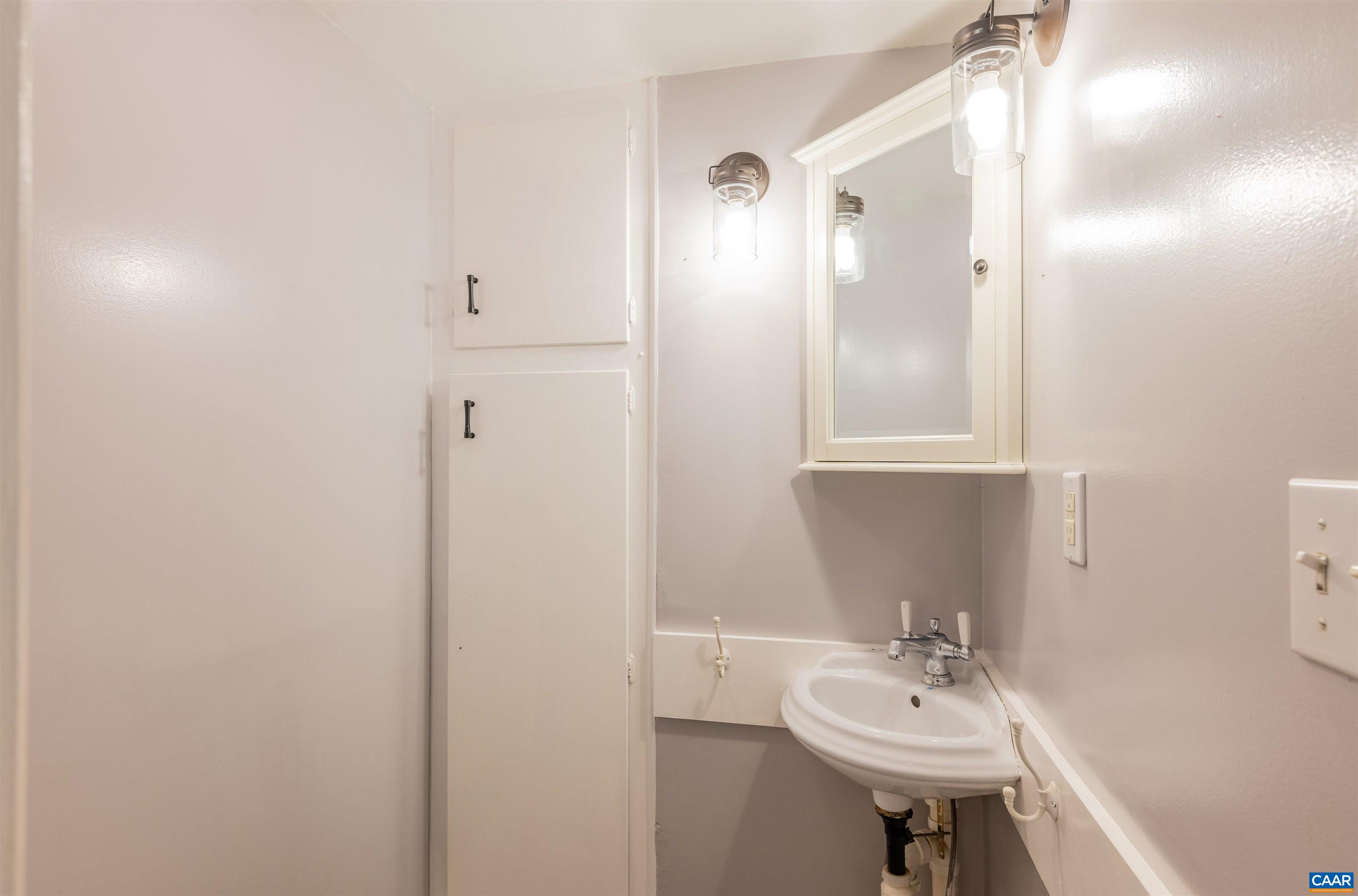 3882 Firehouse Road Howardsville, VA 24562 - Photo 27 of 75 a bathroom with a sink a mirror and shower