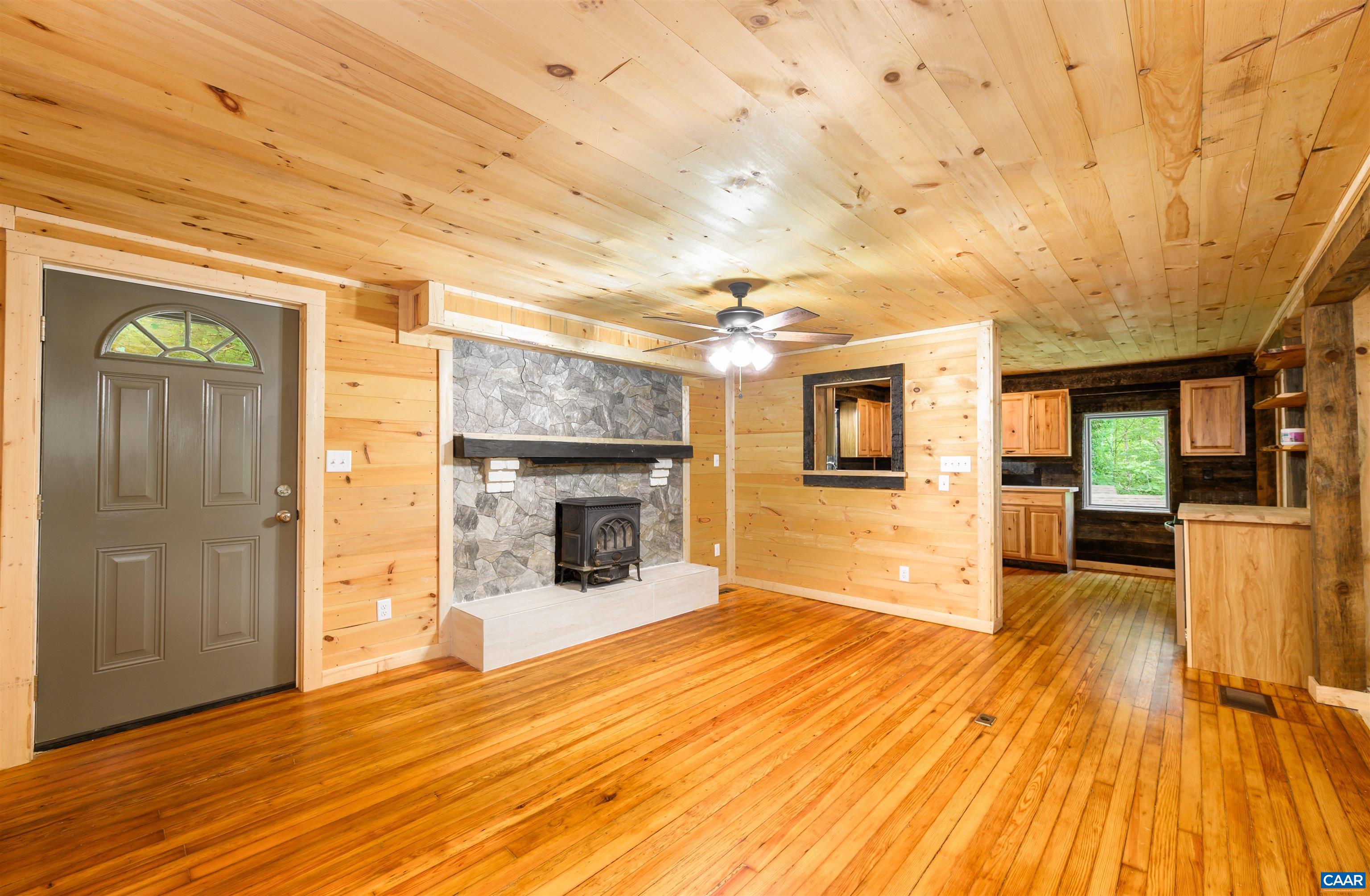3882 Firehouse Road Howardsville, VA 24562 - Photo 5 of 75 a view of a livingroom with wooden floor and a fireplace